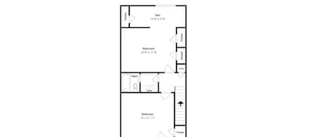 Plano de planta que muestra dos dormitorios, un espacio de salón, un baño y un balcón.