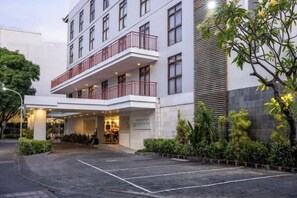 Un hôtel doté d’une entrée abritée, de plusieurs étages et d’un espace de stationnement.