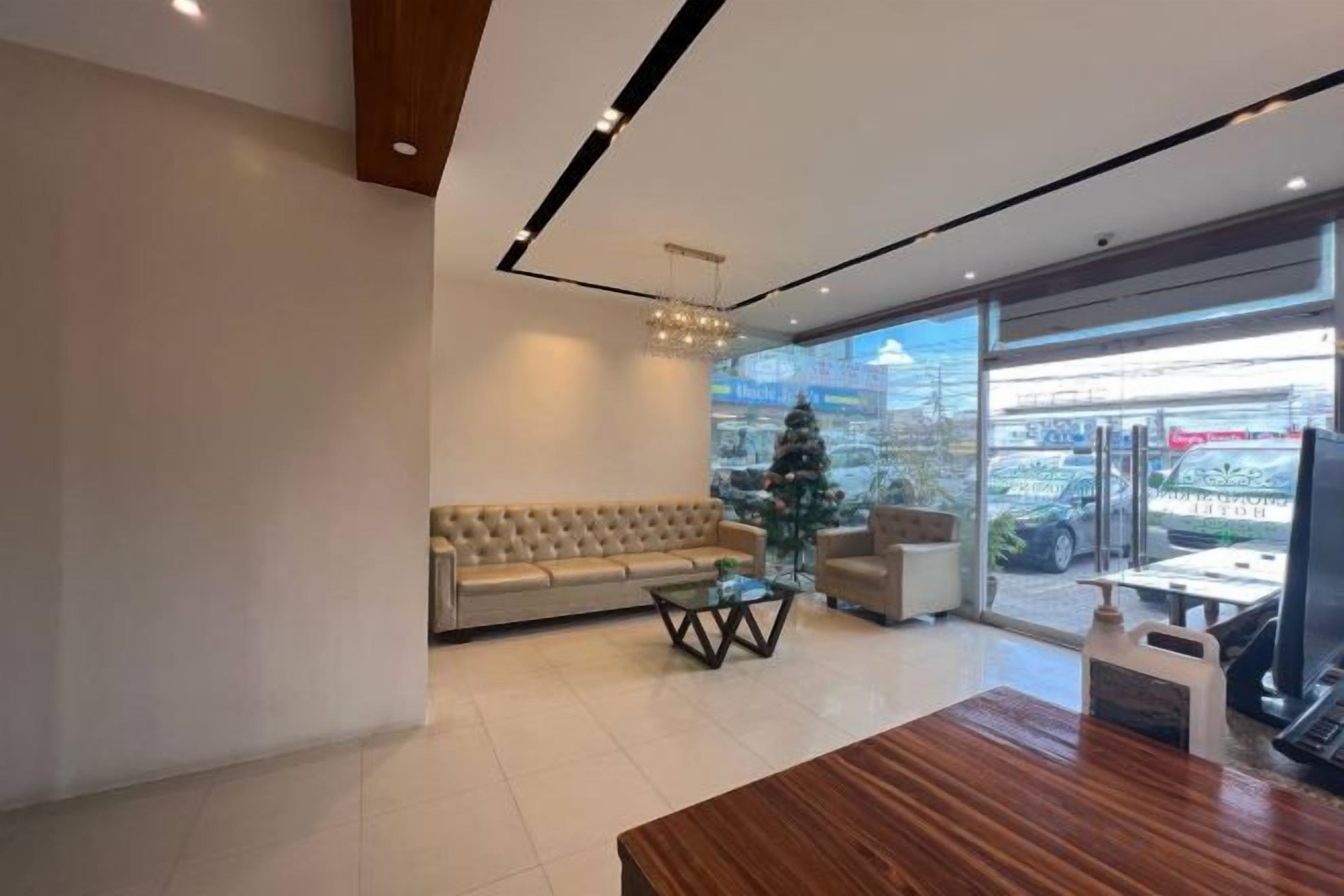 A modern interior with a sofa, a coffee table, and a wooden dining table.