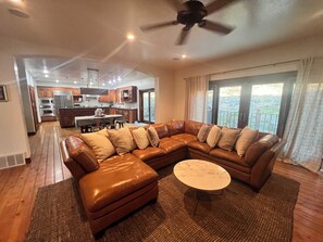 Relax in the living area with a comfortable sofa and enjoy the view from the sliding glass door.