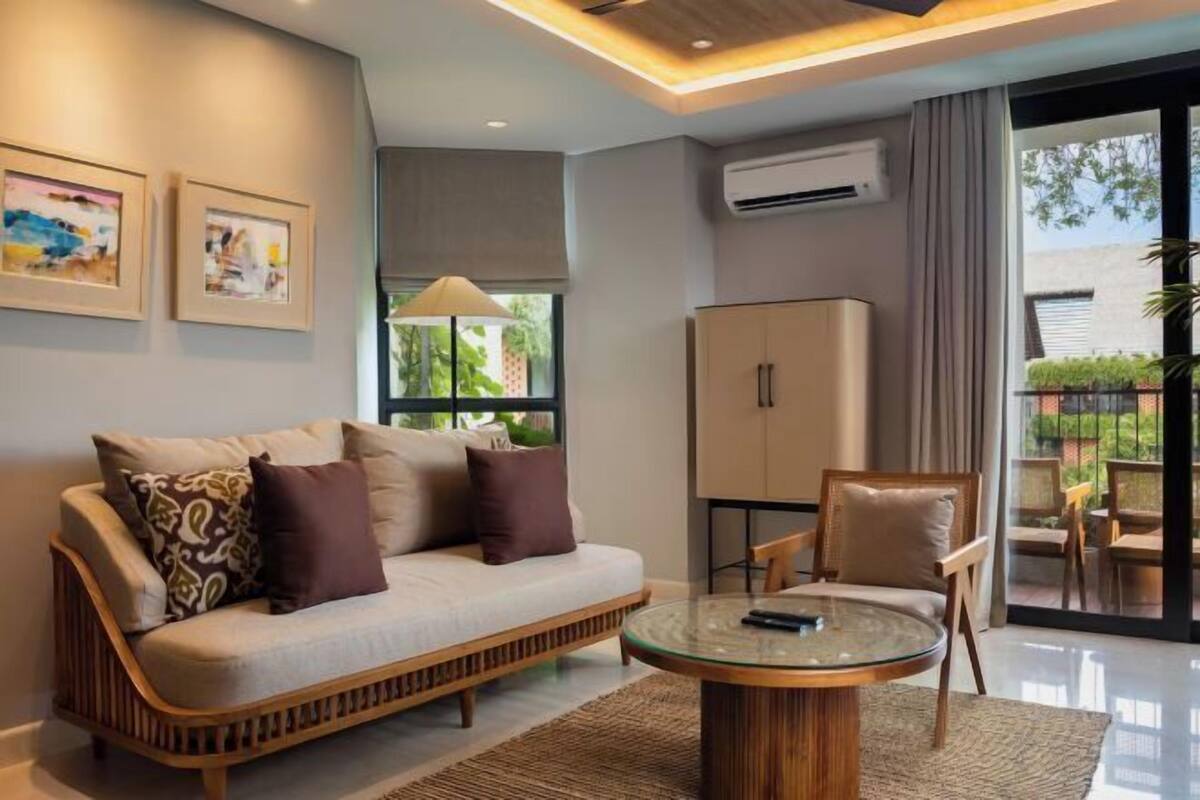 A modern living room with a sofa, a glass coffee table, and a cabinet.