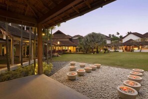 A resort courtyard with outdoor seating and a pool area. - Ramada Resort Cochin (Kochi)