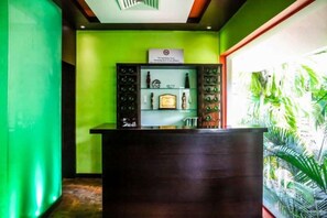 A reception area with a reception desk, a green wall, and a tropical plant display. - Ramada Resort Cochin (Kochi)