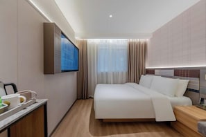 A modern hotel room with a large bed, a flat-screen TV mounted on the wall, a bedside table with a lamp, and a window with curtains. - Homeinn Plus Hotel (Shanghai Bund Nanjing Road Pedestrian Street) (Shanghai)