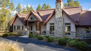 A two-story stone house with a stone chimney, a wrap-around porch, and a stone exterior. - Beautiful 4-bedroom house on 8 acres near Fraser - privacy and amazing views!
 (Fraser)