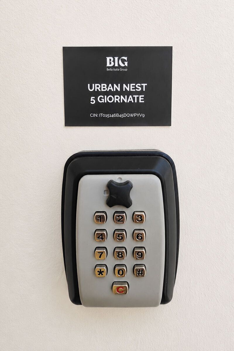 A wall-mounted telephone with a keypad and a card above it.