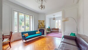 A spacious living room with a blue sofa, a brown leather sofa, and a fireplace. - Pet friendly home in Chabris with WiFi (Chabris)