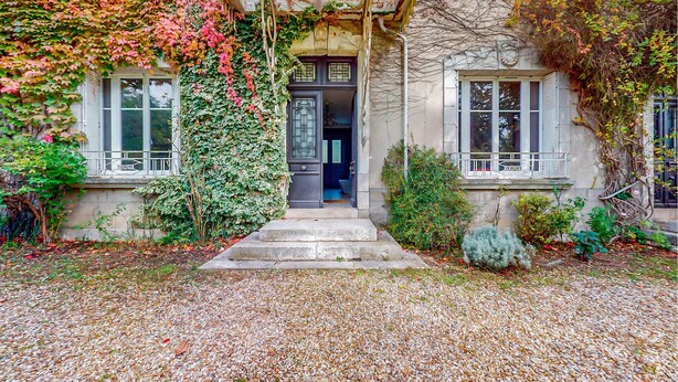 A traditional European-style building with a stone facade, a wooden porch, and a gravel pathway leading to the entrance. - Pet friendly home in Chabris with WiFi (Chabris)