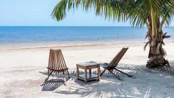 On the beach, white sand, beach towels, beach massages