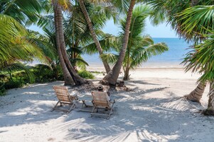 On the beach, white sand, beach towels, beach massages