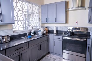 Microwave, oven, stovetop - North Ritz Villa - 2 Bedroom Apartment on the Second Floor (Ocho Rios, Draxhall, St. Ann)