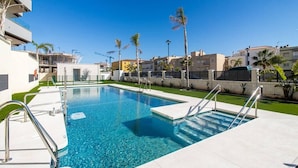 A rectangular swimming pool with clear blue water, surrounded by a white tiled deck and metal railings. - Marinsa Beach,3 bed penthouse (Llanos, Los (Torrox-Costa))