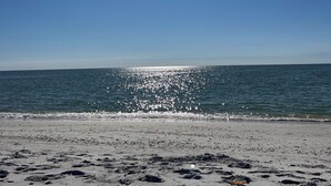 A beach with a clear sky and calm sea.