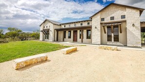 A two-story stone house with a covered patio and a large front lawn. - Welcome to Little Blanco! Bonus: Free Golf During Your Stay! (Concan)