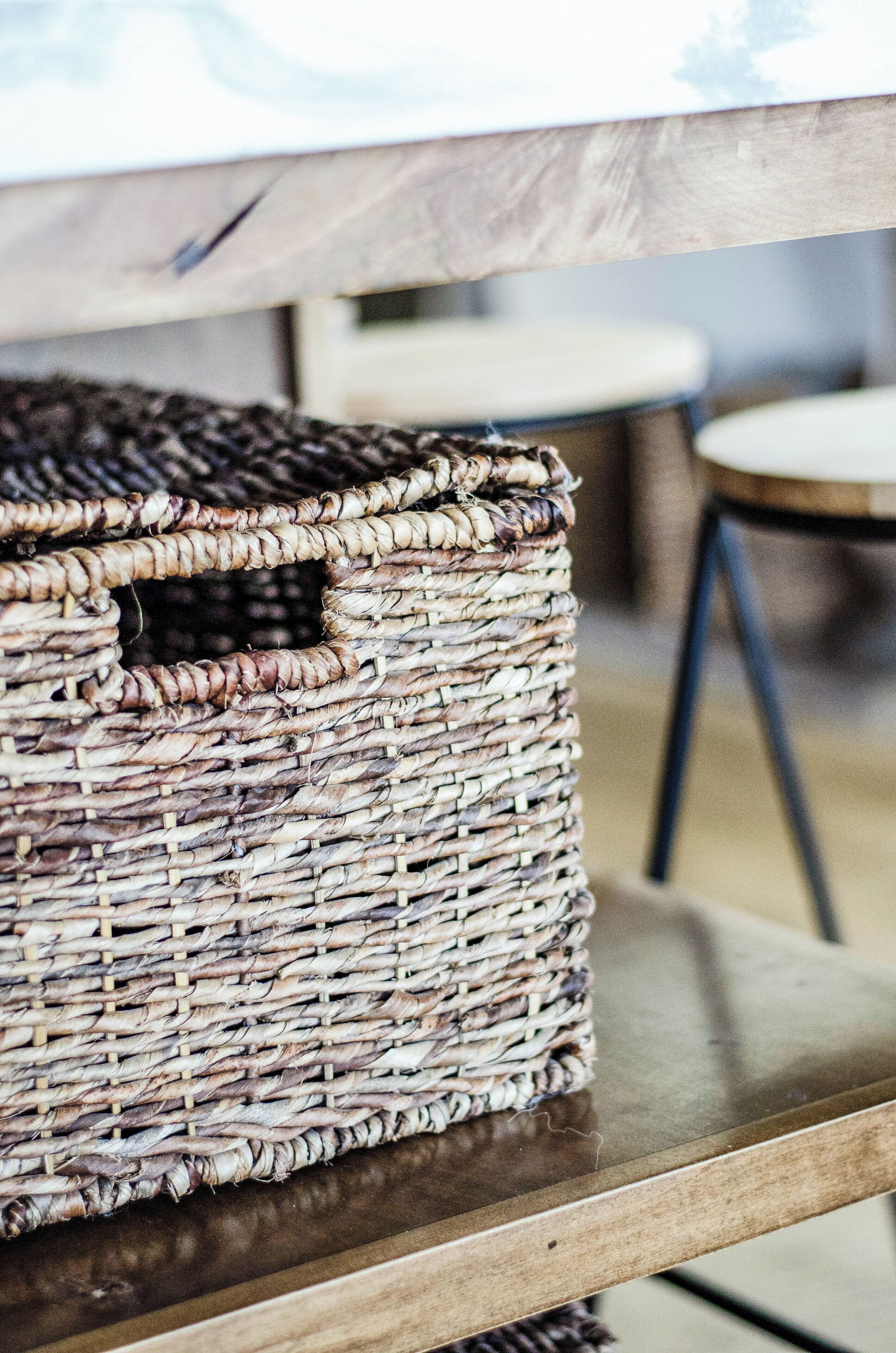 A wicker basket on a wooden table.