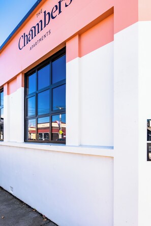 A building with a sign reading 'The Chambers Apartments.'