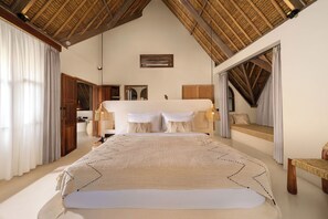 A spacious bedroom with a large bed, wooden ceiling beams, and a view of a balcony. - Villa Xanadu Pererenan by Nakula (Canggu)