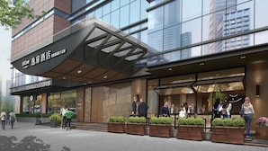 A modern building with a Starbucks Coffee sign, a covered entrance, and people outside. - UrCove by Hyatt Suzhou Shantang Street (Suzhou)