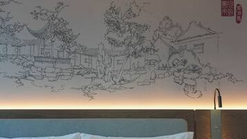 A room with a traditional Chinese mural on the wall, a bed with white bedding, and a wooden headboard.