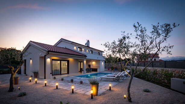 A modern house with a swimming pool, outdoor lighting, and a landscaped garden. - Holiday House Jewel With Private Pool (Krk)