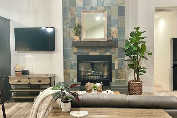 Cozy living room has a huge slate gas fireplace and swivel TV