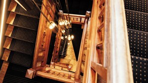 A spiral staircase with wooden railings and a geometric ceiling design. - Villa37 (Limoges)