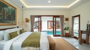 A bedroom with a large bed, a view of a swimming pool, and a door leading to an outdoor area. - Villa Lange 2 by Villa Finder (Seminyak)