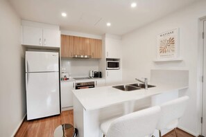 Fridge, microwave, oven, stovetop - Ground Level 1-Bed: Courtyard & Alfresco Dining (Wright)