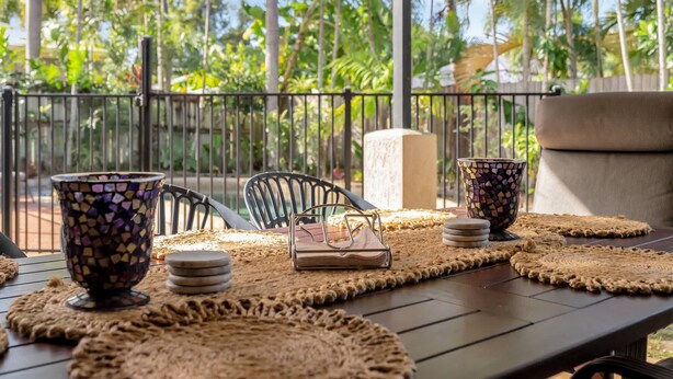 A patio with woven placemats, a mosaic coffee cup, a woven basket, and a woven mat.
