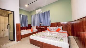 Family Room | Minibar, in-room safe, individually decorated, desk