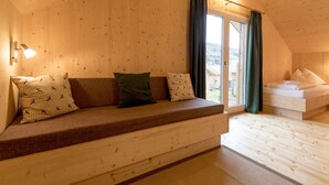 A cozy wooden cabin room with a built-in bench and a bed.