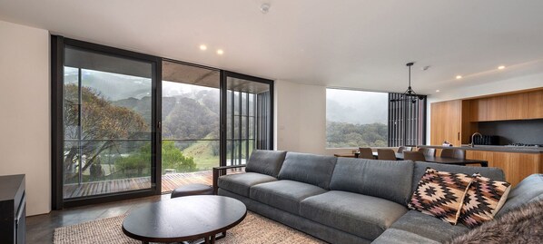 Enjoy a panoramic view of the surrounding mountains from the large window in this stylish living space.