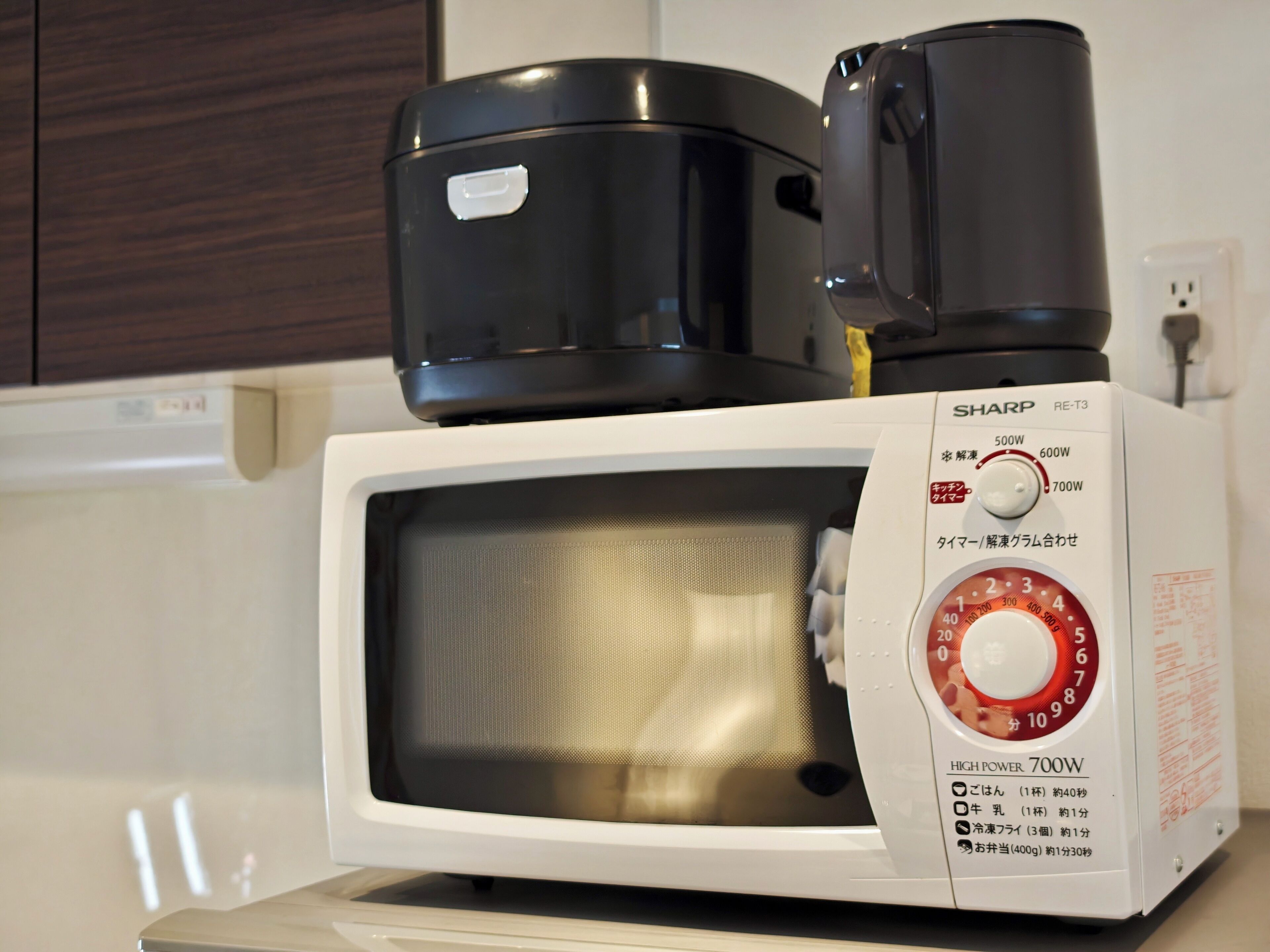 A microwave oven with a digital display and a power dial.