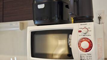 A microwave oven with a digital display and a power dial.