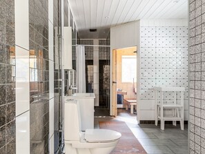 A modern bathroom with a glass shower enclosure, a white toilet, and a sink with a mirror. - Erikstorp 149 by Interhome (Olofström)