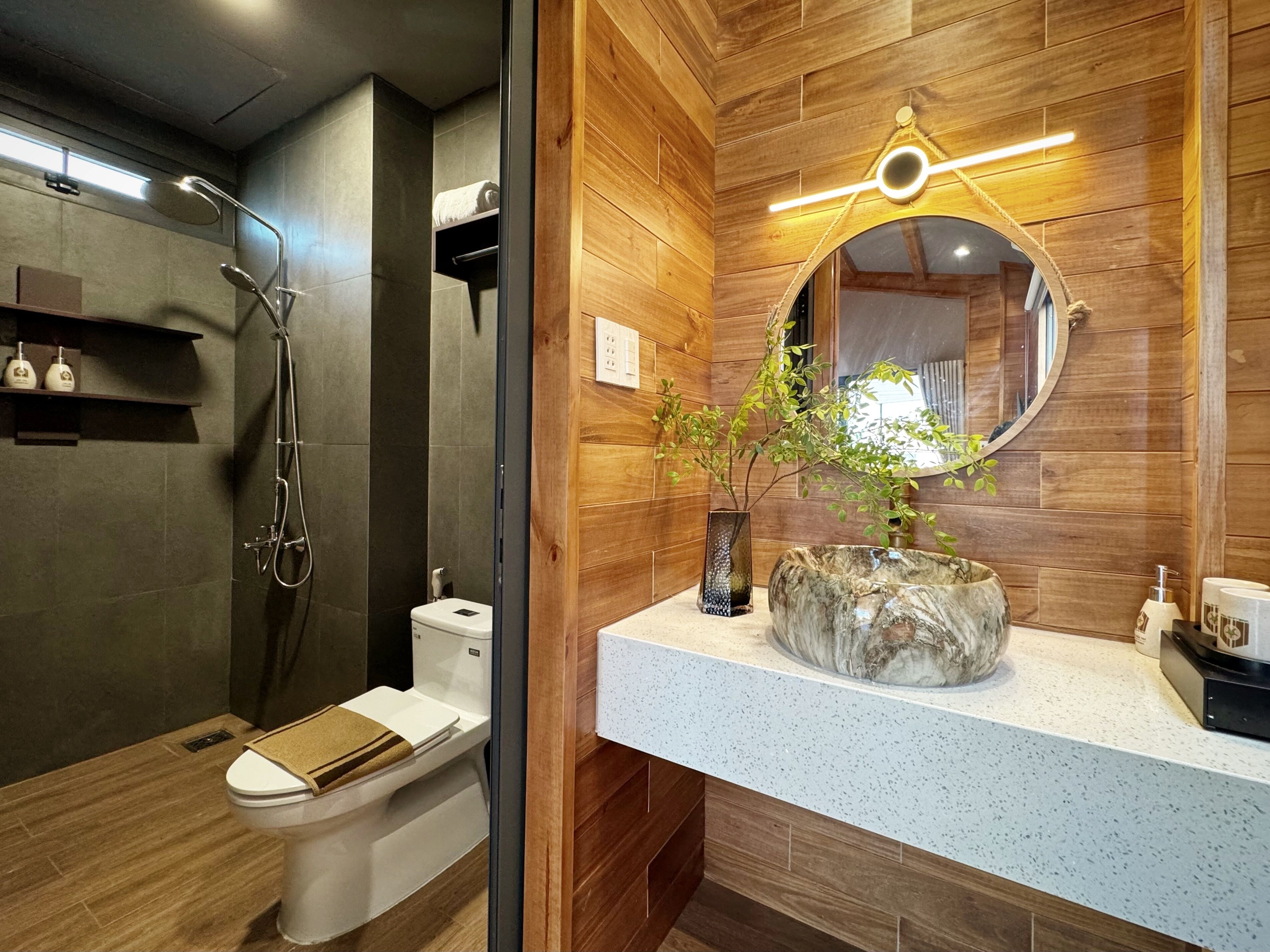 A modern bathroom with a shower, toilet, and vanity.