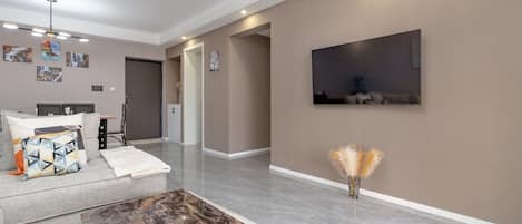 A modern living room with a sofa, coffee table, and artwork on the walls.