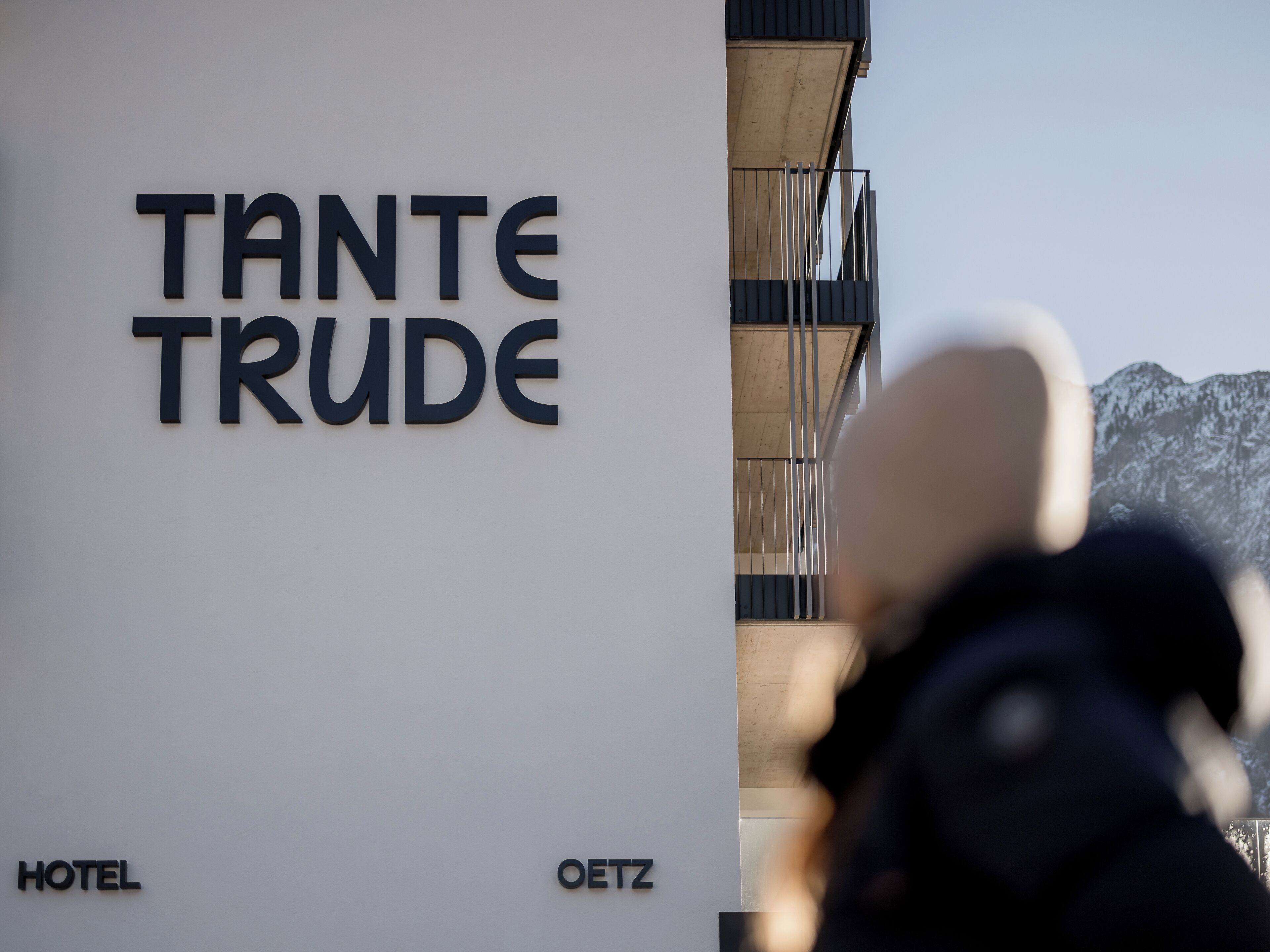 A hotel sign with the name "TANTE TRUDE HOTEL" and "OETZ" below it.