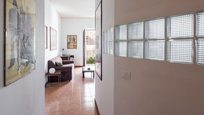 A spacious living room with a sofa, coffee table, and artwork on the walls. - Casa all Anfiteatro di Catania by Wonderful Italy (Catania)