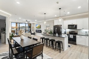Enjoy cooking in this well-equipped kitchen with a central island, microwave, oven, and ample counter space.