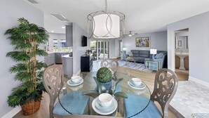 A dining area with a round table, chairs, and a decorative centerpiece. - Remodeled Waterfront Home w/ Heated Pool  in Punta Gorda (Punta Gorda)