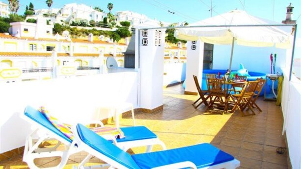 A terrace with lounge chairs, a table, and a tent. - Apartment 'Fernandes' with Mountain View, Wi-Fi and Air Conditioning (Carvoeiro)