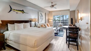 A hotel room with a large bed, a desk, a chair, a ceiling fan, and a balcony with a view. - Tranquil 3rd Floor Retreat: 2 Bedroom, 3 Bath, and two King Beds at Sandestin Golf and Beach Resort! (Miramar Beach)