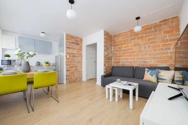 A living space with bright yellow chairs, a dining table, and a cozy white interior.
