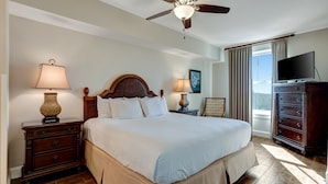 A hotel room with a large bed, two bedside tables with lamps, a ceiling fan, a dresser, and a television. - Stunning Bay Views on the 6th Floor:  Two bedroom with Fully Equipped Kitchen, Sleeper Sofa at Sandestin Golf and Beach Resort! (Miramar Beach)