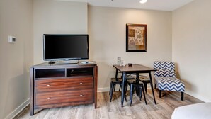 A hotel room with a wooden desk, a television, a framed artwork, and a patterned chair. - Relaxing Oasis in Luau: Serene Two-Bedroom Retreat with 3 Beds and Scenic Views at Sandestin Golf and Beach Resort! (Miramar Beach)