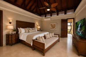 A spacious bedroom with a large bed, a wooden headboard, a ceiling fan, and a television on a wooden cabinet.