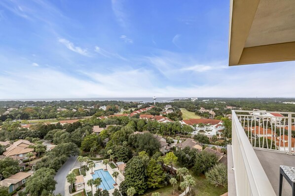 A residential area with houses, a swimming pool, and a distant tower.