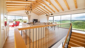 A spacious kitchen with a large island, wooden beams on the ceiling, and a view of the countryside through large windows. - Villa Sanpadeo Nearby Novigrad - Crovillas (Brtonigla)