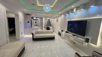 Family Room, Balcony, City View | Living area | Flat-screen TV, video game console